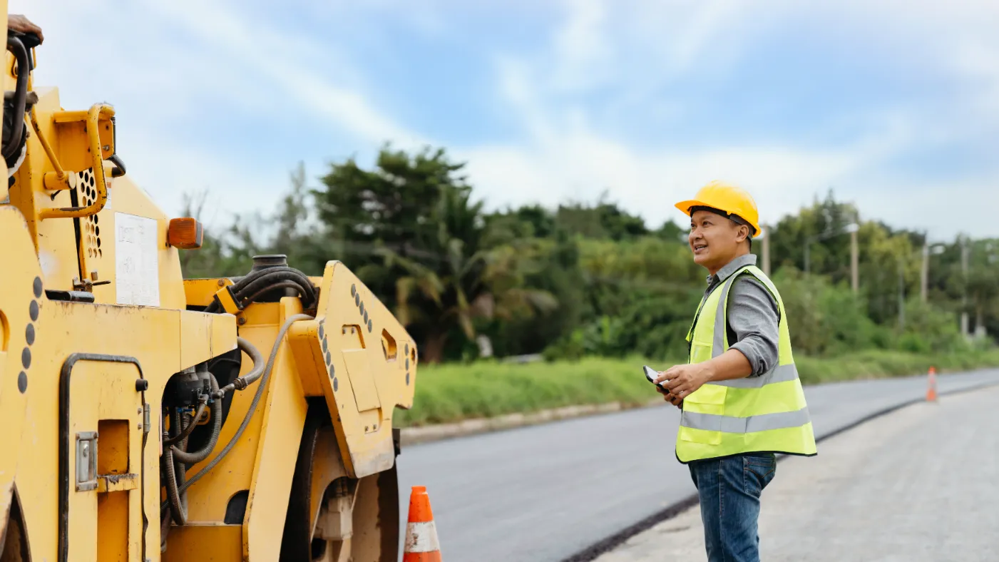 A worker supervising the heavy equipment.